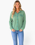 Beach Rose Co. sage green waffle knit button-front shirt with chest pockets worn by a smiling woman in blue jeans