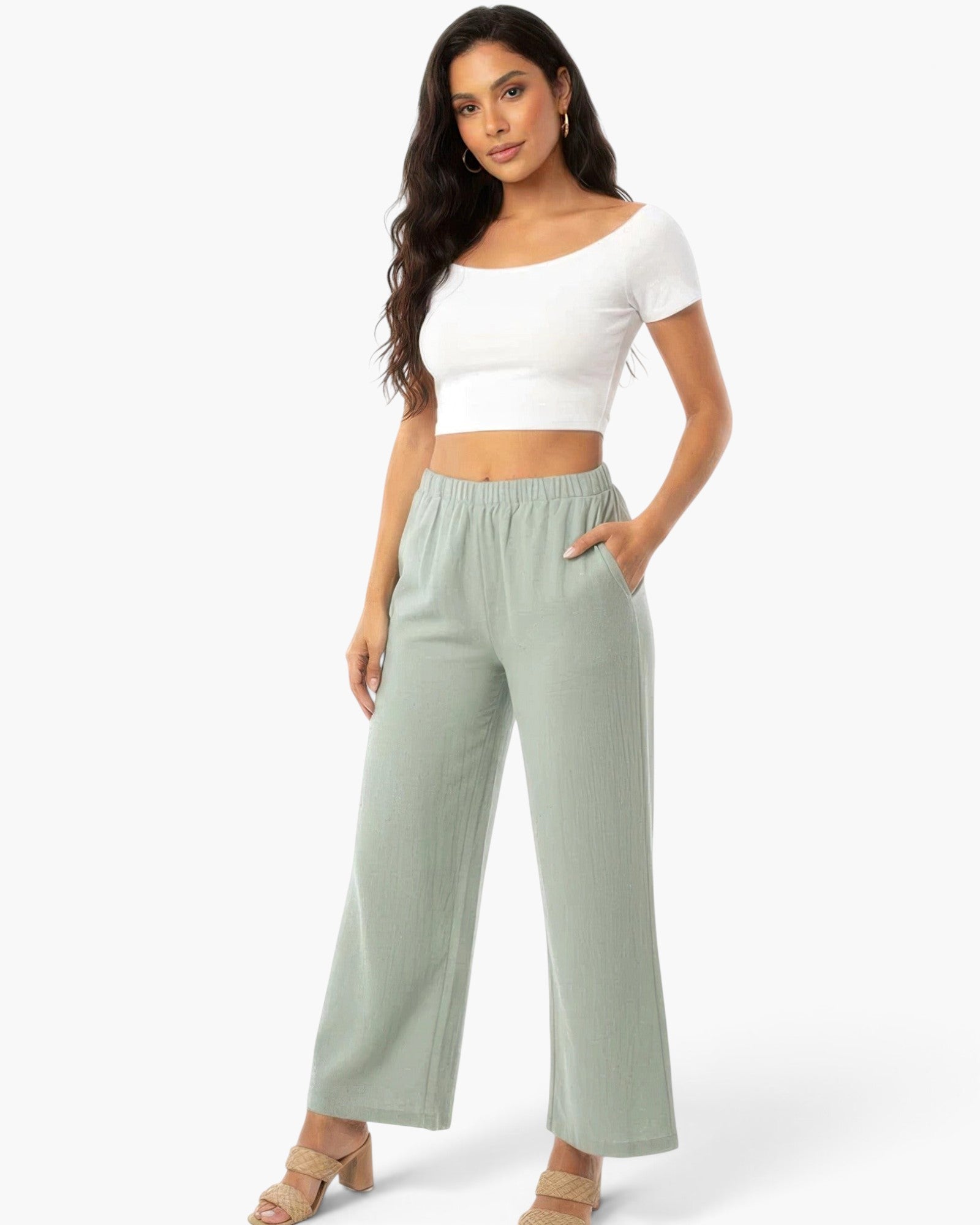 Model wearing Beach Rose Co. sage green relaxed fit wide-leg cotton pants with side pockets and a white crop top
