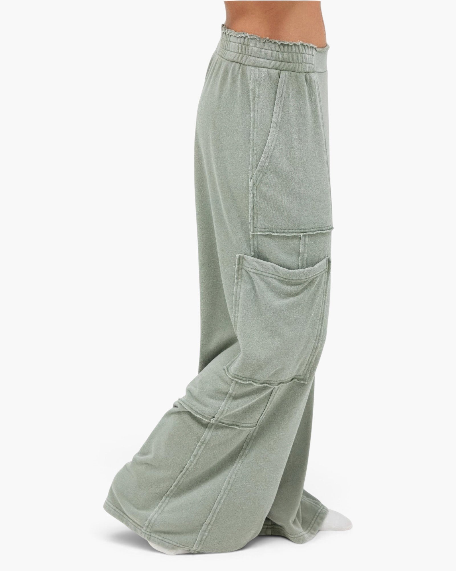 Beach Rose Co. sage green mineral wash cotton cargo pants with a high-rise elastic waistband and raw edge pockets.