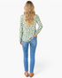 Beach Rose Co. sage green long-sleeve blouse with black and white polka dots, worn with blue jeans, back view