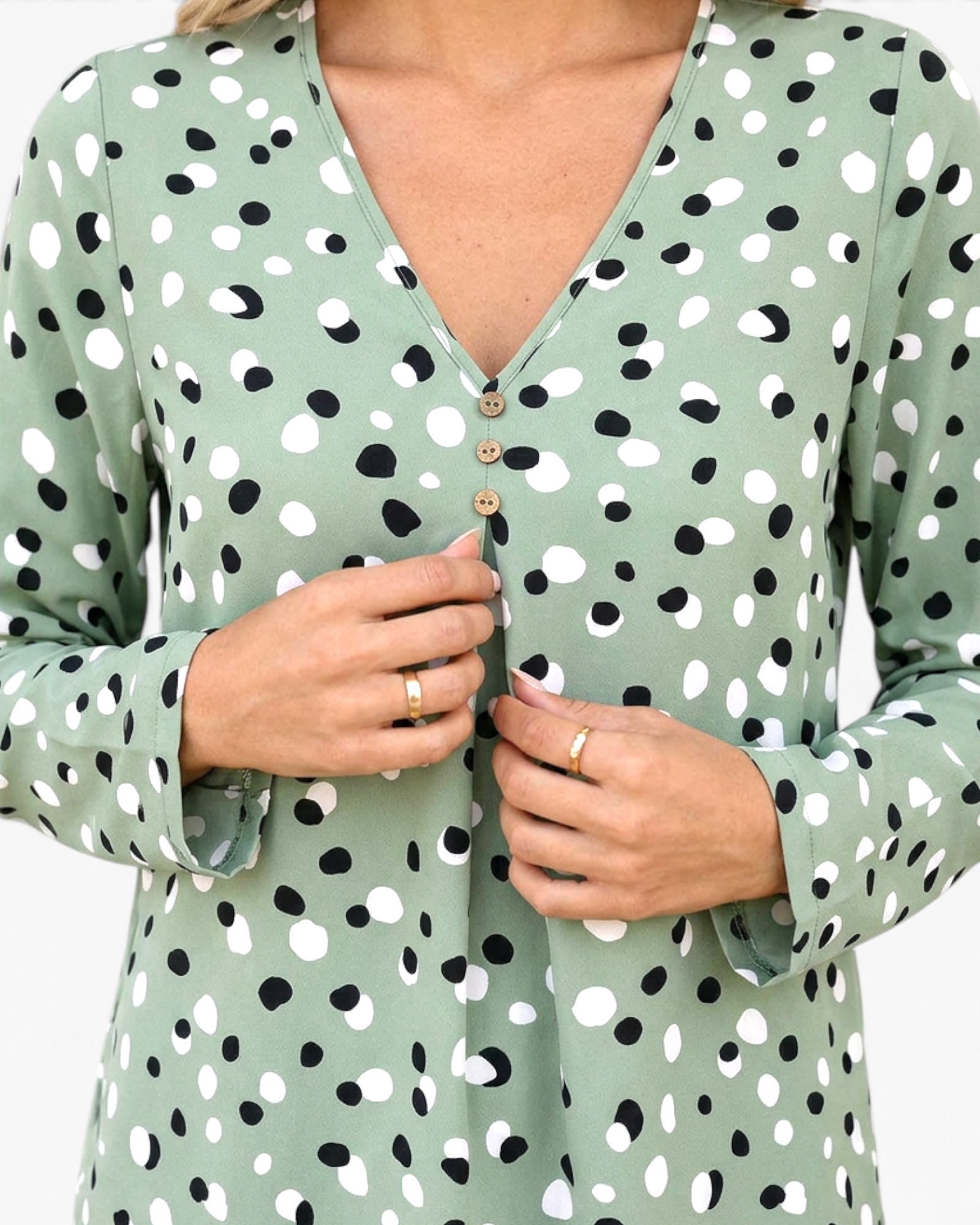 Beach Rose Co. sage green polyester blouse with black and white polka dots, V-neckline, and three-button detail.