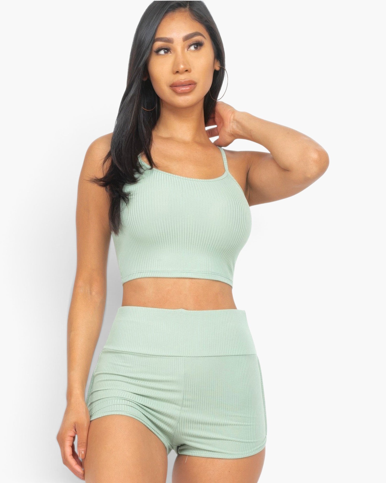 Beach Rose Co. model wearing a sage green ribbed cami crop top and matching high-waisted ruched shorts set.