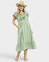 Beach Rose Co. sage green textured midi dress with ruffled V-neck, flutter sleeves, and pockets.