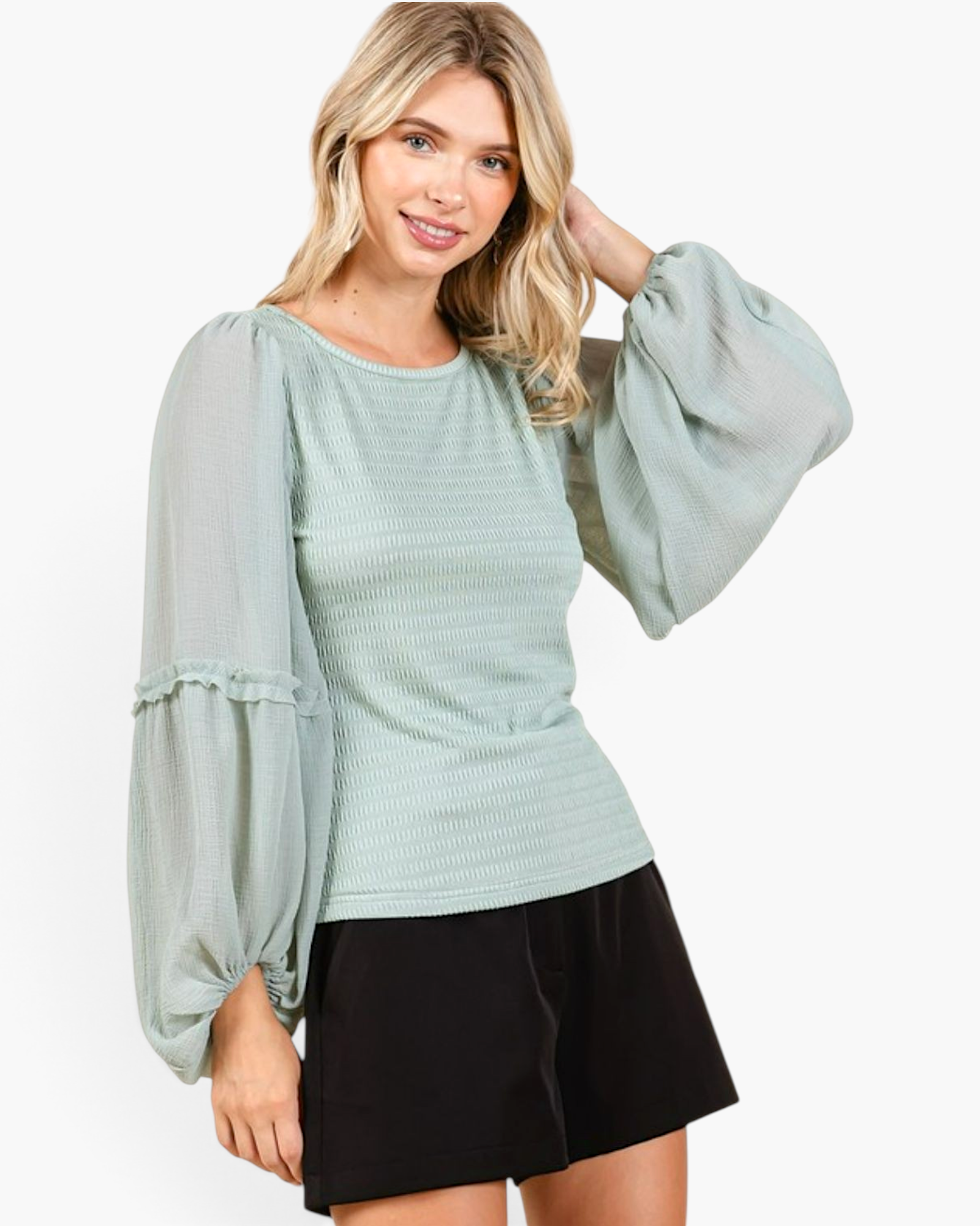Beach Rose Co. sage smocked chiffon blouse with sheer balloon sleeves and ruffle trim worn by a blonde model