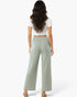 Beach Rose Co. relaxed fit wide-leg cotton pants in sage green worn by a woman from the back view