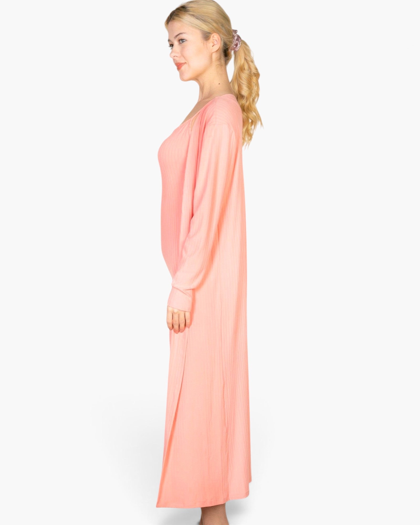 Beach Rose Co. salmon pink ribbed midi bodycon dress and matching long cardigan set worn by a blonde model side view