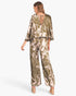 Beach Rose Co. Dreaming Lily satin cape jumpsuit in olive green with floral print, featuring a back tie detail.