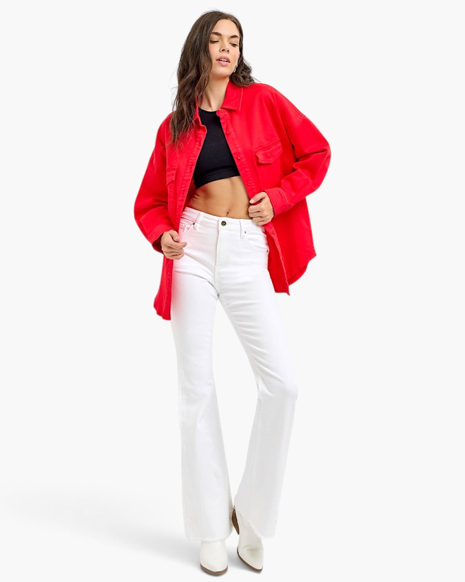 Model wearing a Beach Rose Co. scarlet oversized denim shirt jacket with buttoned pockets and a curved hem.