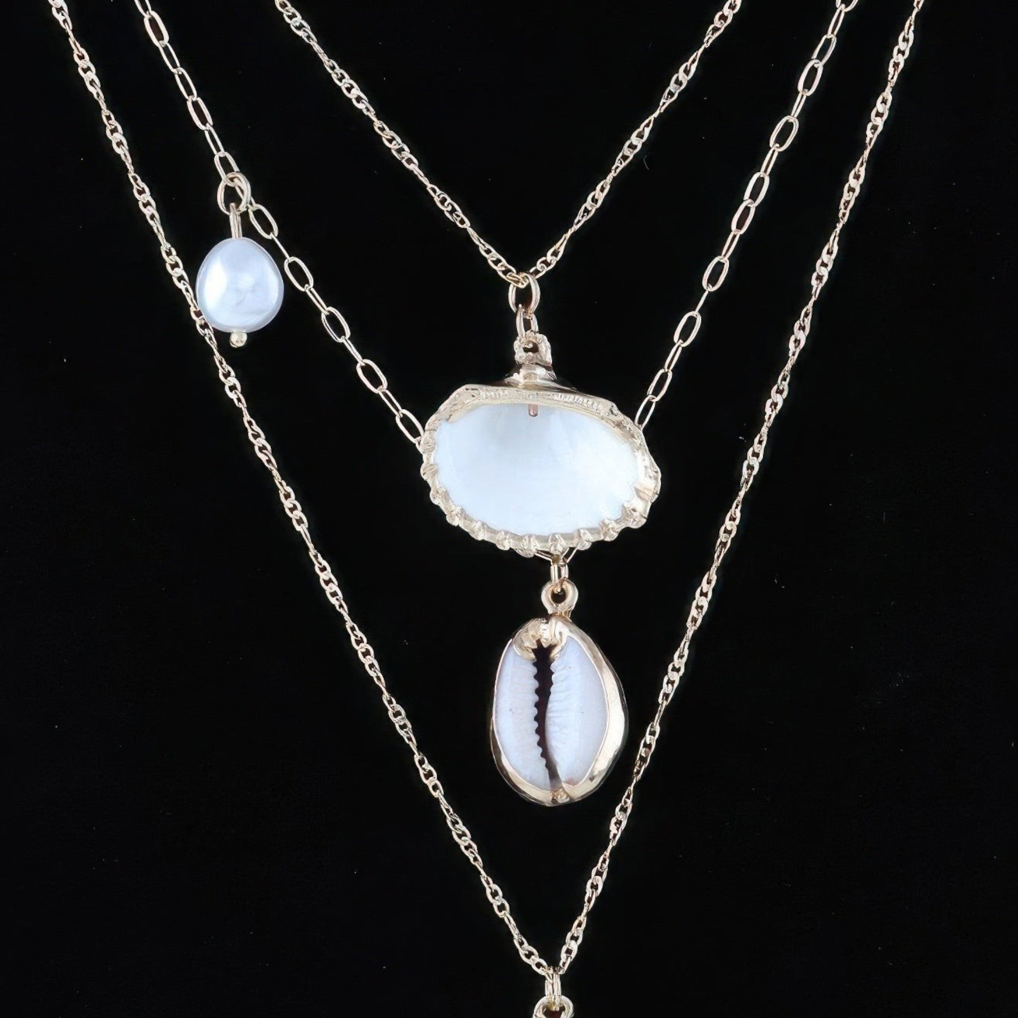 Beach Rose Co. gold chain necklace featuring seashell and starfish charms for a coastal, whimsical look.