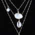 Beach Rose Co. gold chain necklace featuring seashell and starfish charms for a coastal, whimsical look.