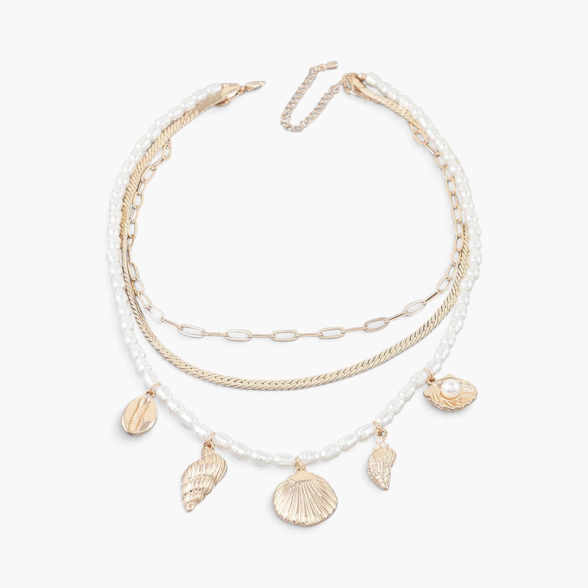 Beach Rose Co. multi-strand necklace featuring gold chains, white pearls, and dangling gold seashell charms.