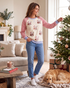 Beach Rose Co. cream sweatshirt with sequin Santa motifs and red gingham raglan sleeves worn by a woman decorating.