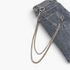 Beach Rose Co. silver-tone double layer pants chain with contrasting links attached to grey denim jeans