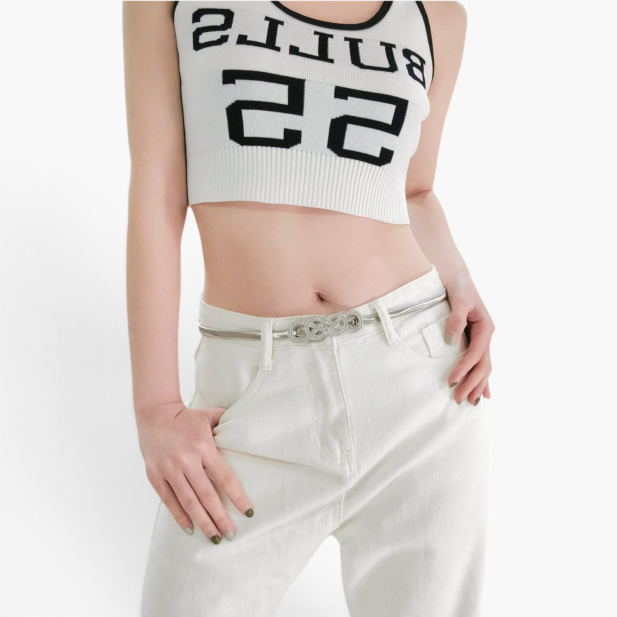 Beach Rose Co. slim silver metal waist belt with an intricate interwoven knot buckle worn over white jeans