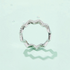 Beach Rose Co. platinum-plated sterling silver zigzag band ring featuring 0.38 carat round moissanite stones.