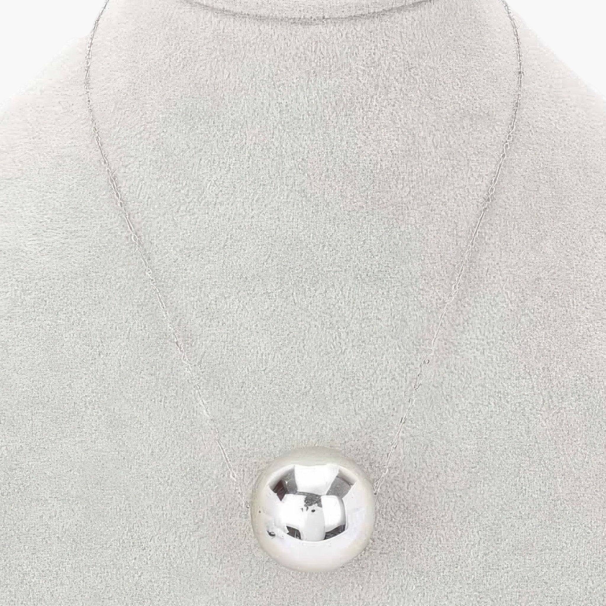 Beach Rose Co. silver round CCB ball pendant necklace on a grey display stand
