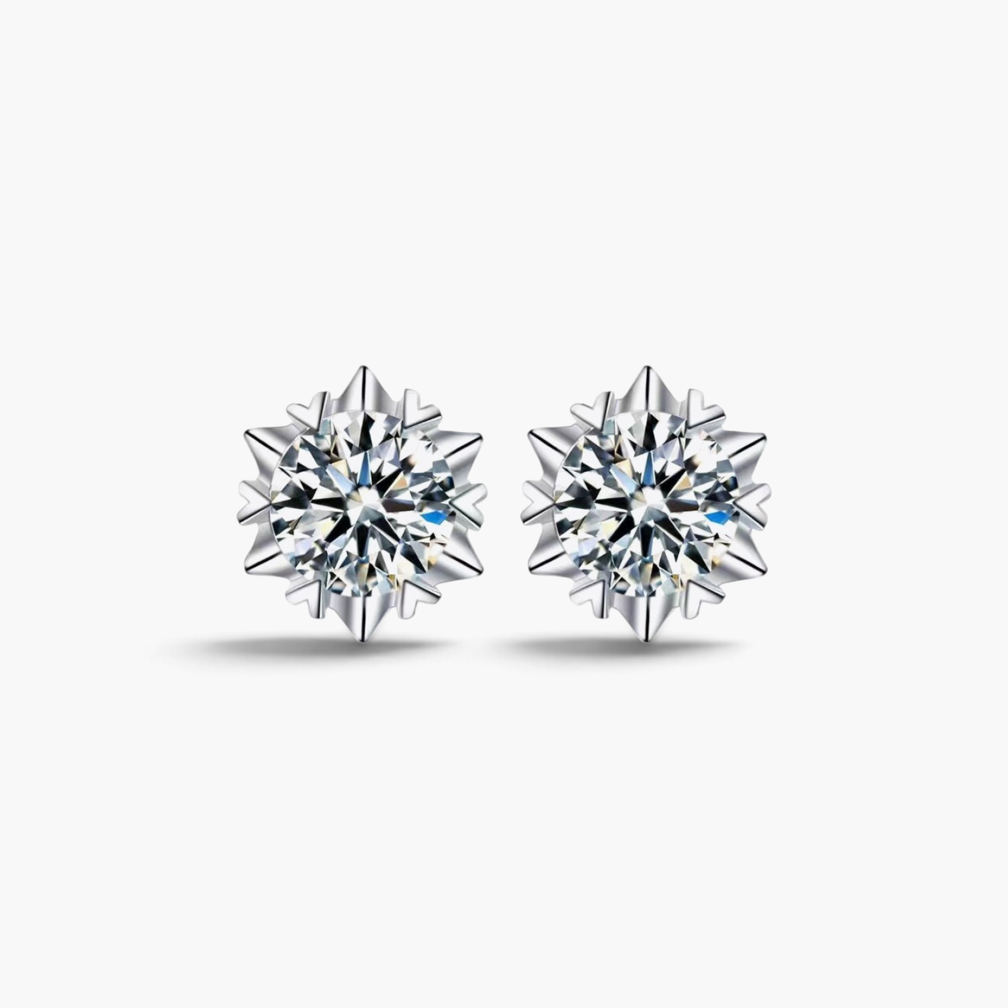 Beach Rose Co. silver starburst moissanite stud earrings with heart-shaped prongs and 4 carat total weight.