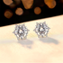 Beach Rose Co. silver starburst moissanite stud earrings with heart-shaped prongs and 4 carat total weight.