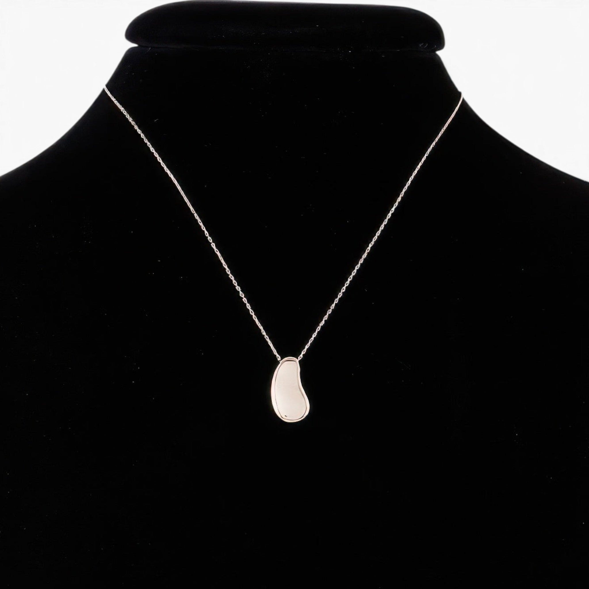 Beach Rose Co. minimalist silver teardrop pendant necklace on a black display bust