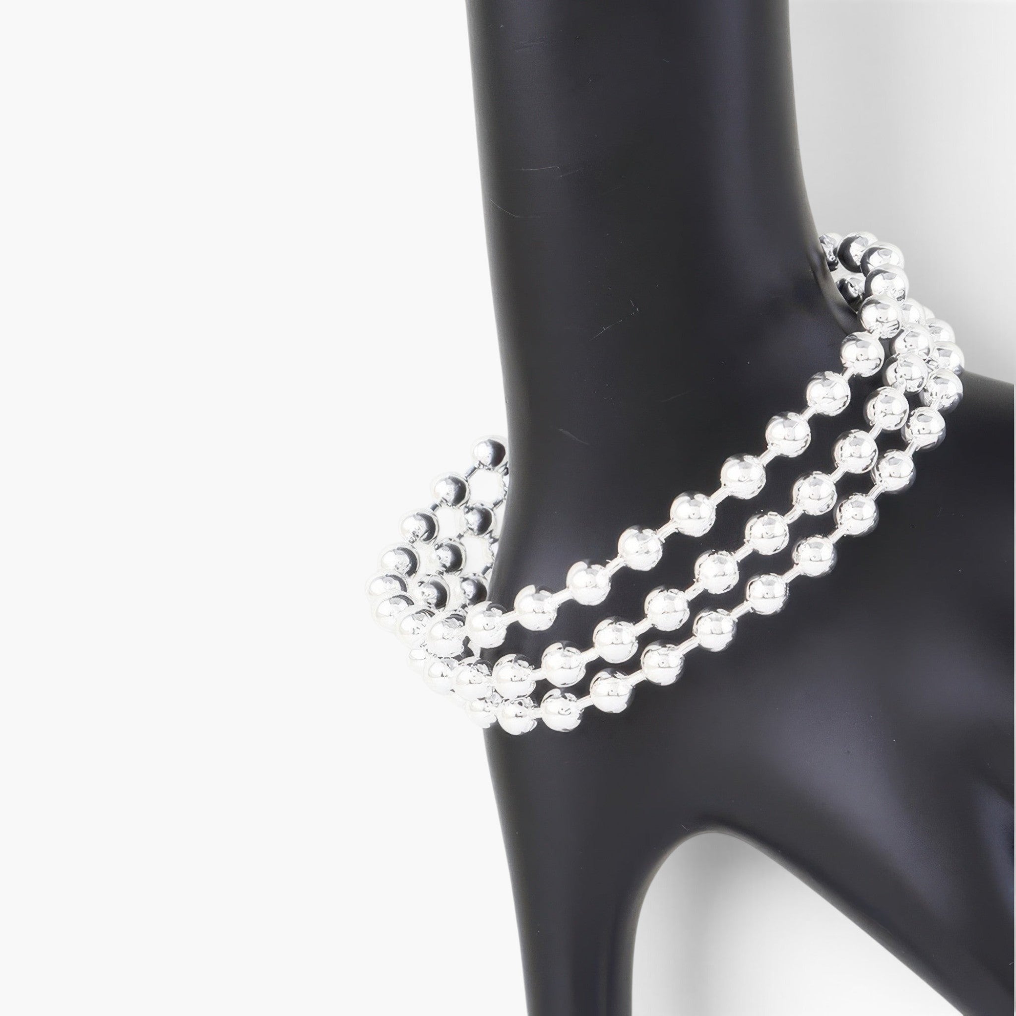 Beach Rose Co. silver triple beaded cuff bracelet on a black display stand, featuring three rows of polished beads.