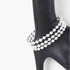 Beach Rose Co. silver triple beaded cuff bracelet on a black display stand, featuring three rows of polished beads.