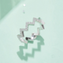 Beach Rose Co. silver zigzag band ring featuring round moissanite stones on a platinum-plated sterling silver setting.