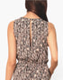 Back view of a Beach Rose Co. sleeveless bubble jumpsuit in a dark abstract print on a light background