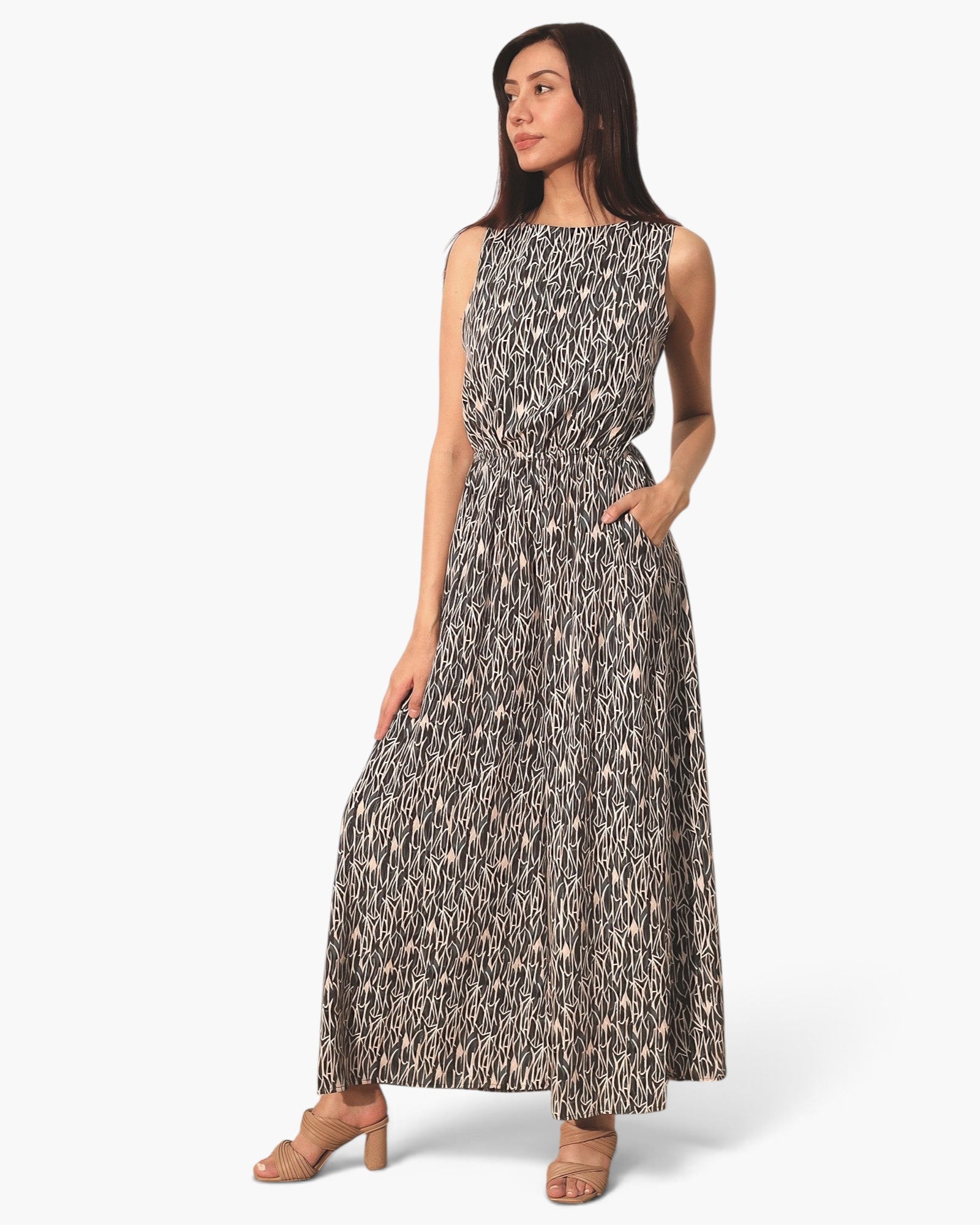 Beach Rose Co. sleeveless bubble jumpsuit in a black and white abstract print worn by a model with tan heels