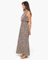 Model wearing Beach Rose Co. sleeveless bubble jumpsuit in a black and white abstract print with tan block heels
