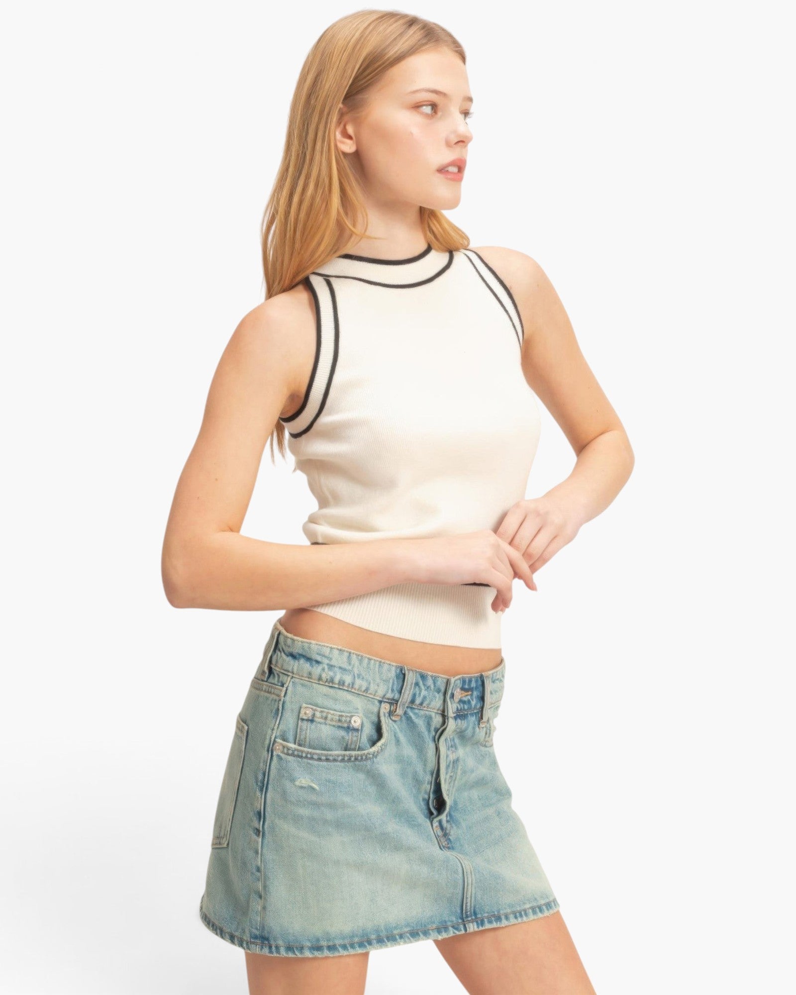 Beach Rose Co. sleeveless ribbed knit top in cream with black contrast trim, worn by a model with a denim skirt.