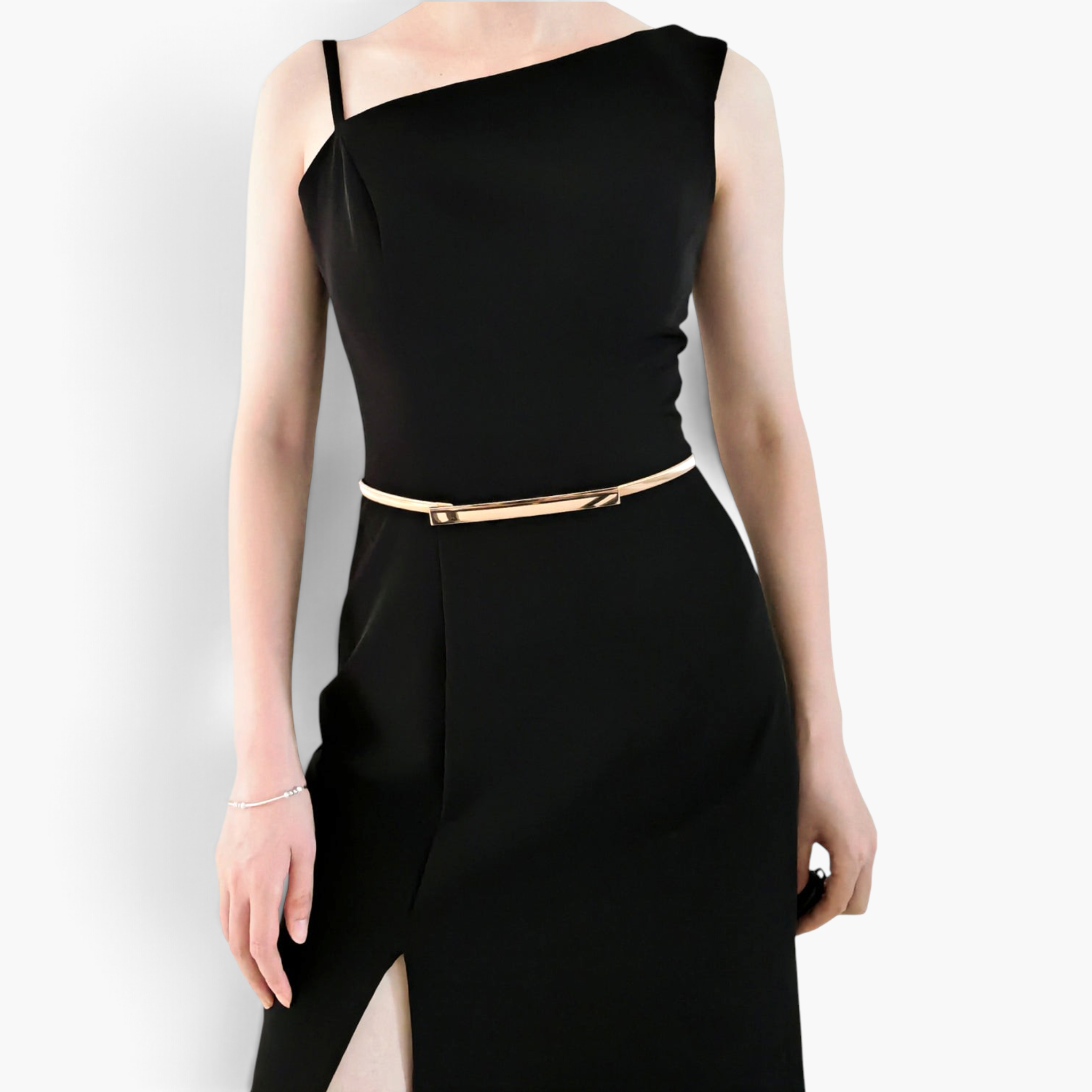 Beach Rose Co. slim gold-tone metal waist belt with a polished rectangular clasp worn over a black dress