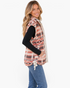 Beach Rose Co. sherpa vest with rust and cream southwestern geometric print, snap front, and side ties on a model.