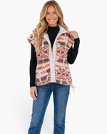 Beach Rose Co. rust and cream southwestern print sherpa vest with snap front and side ties worn by a smiling model.