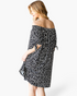 Beach Rose Co. black and ivory spotted off-shoulder dress with tie-sleeve details on a model, back view
