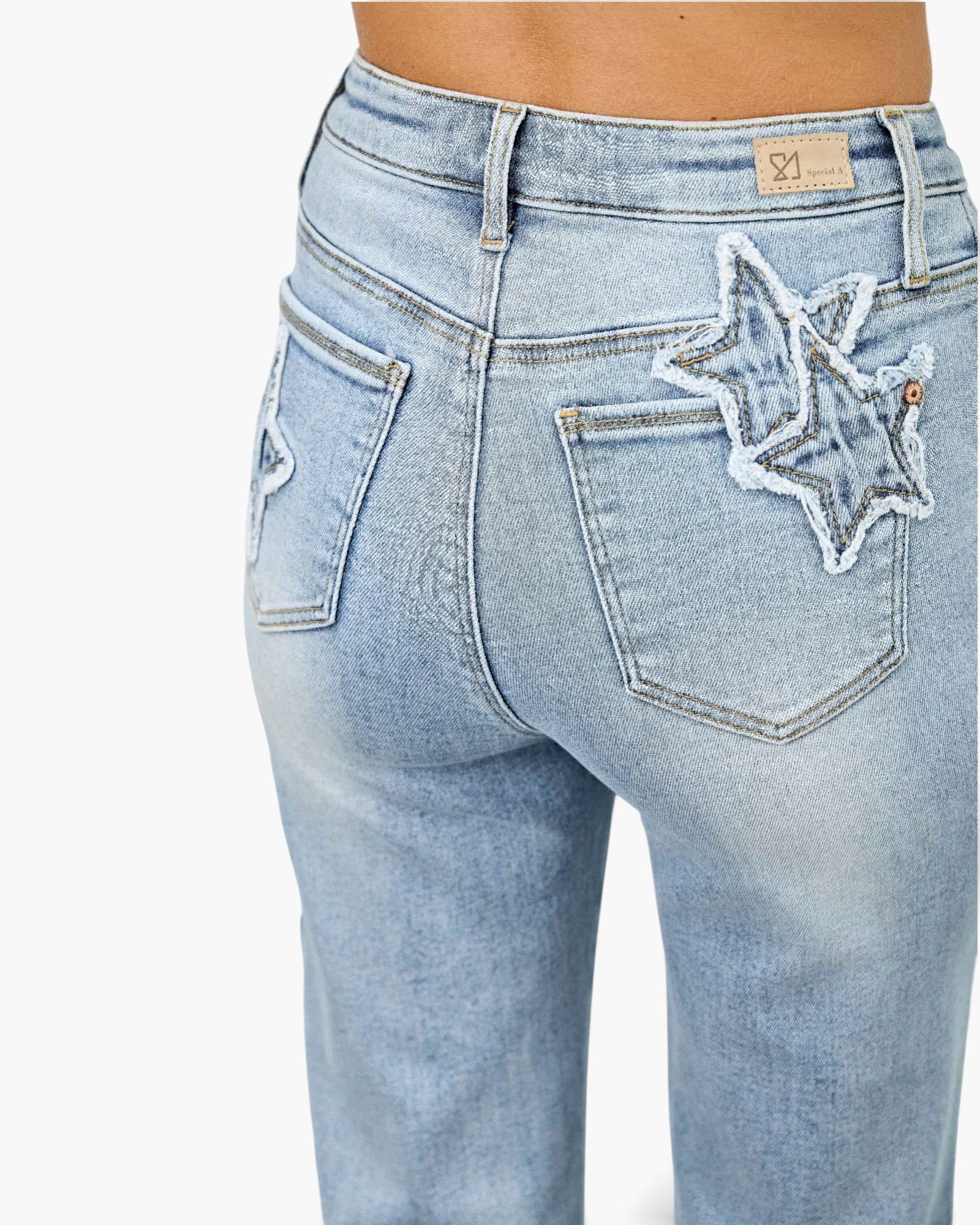 Beach Rose Co. light wash high-rise dad jeans featuring frayed star and heart patchwork on the back pockets.