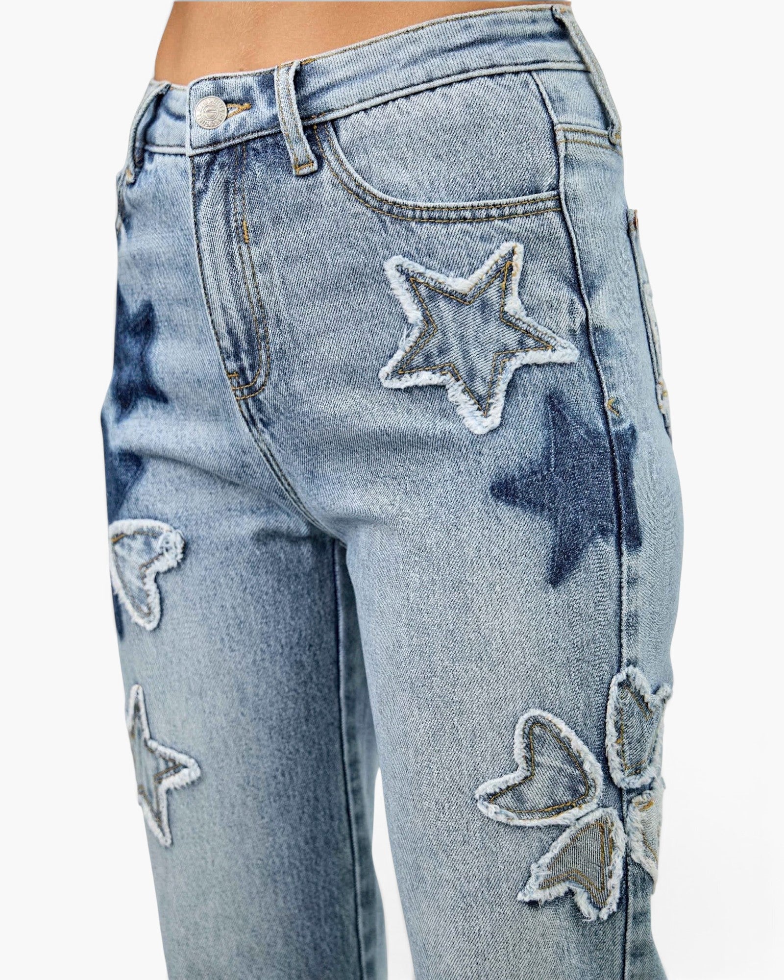 Beach Rose Co. high-rise dad jeans in light wash denim featuring frayed star and heart patchwork details.