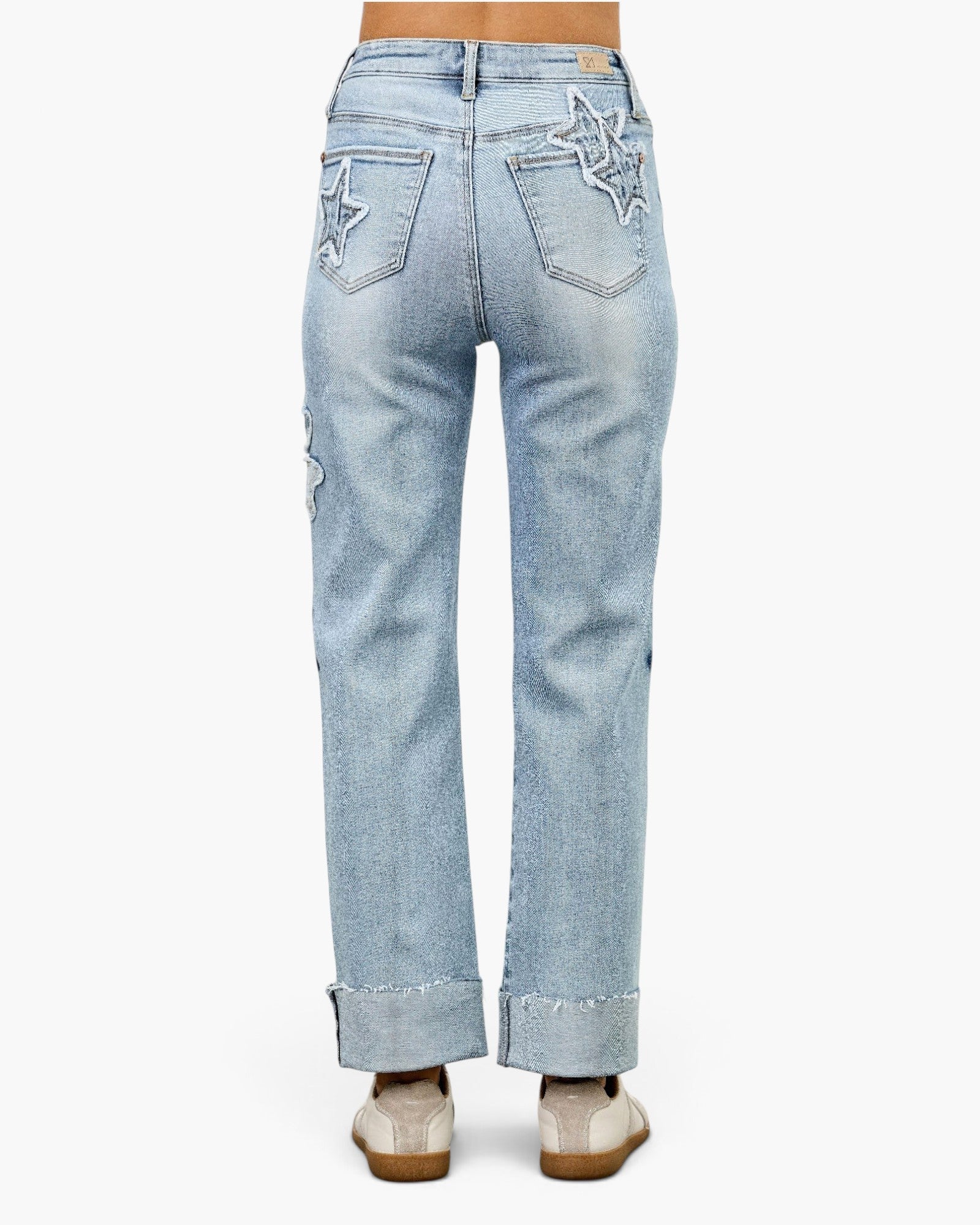 Beach Rose Co. high-rise dad jeans in light wash denim with star and heart patchwork on the back pockets and cuffs