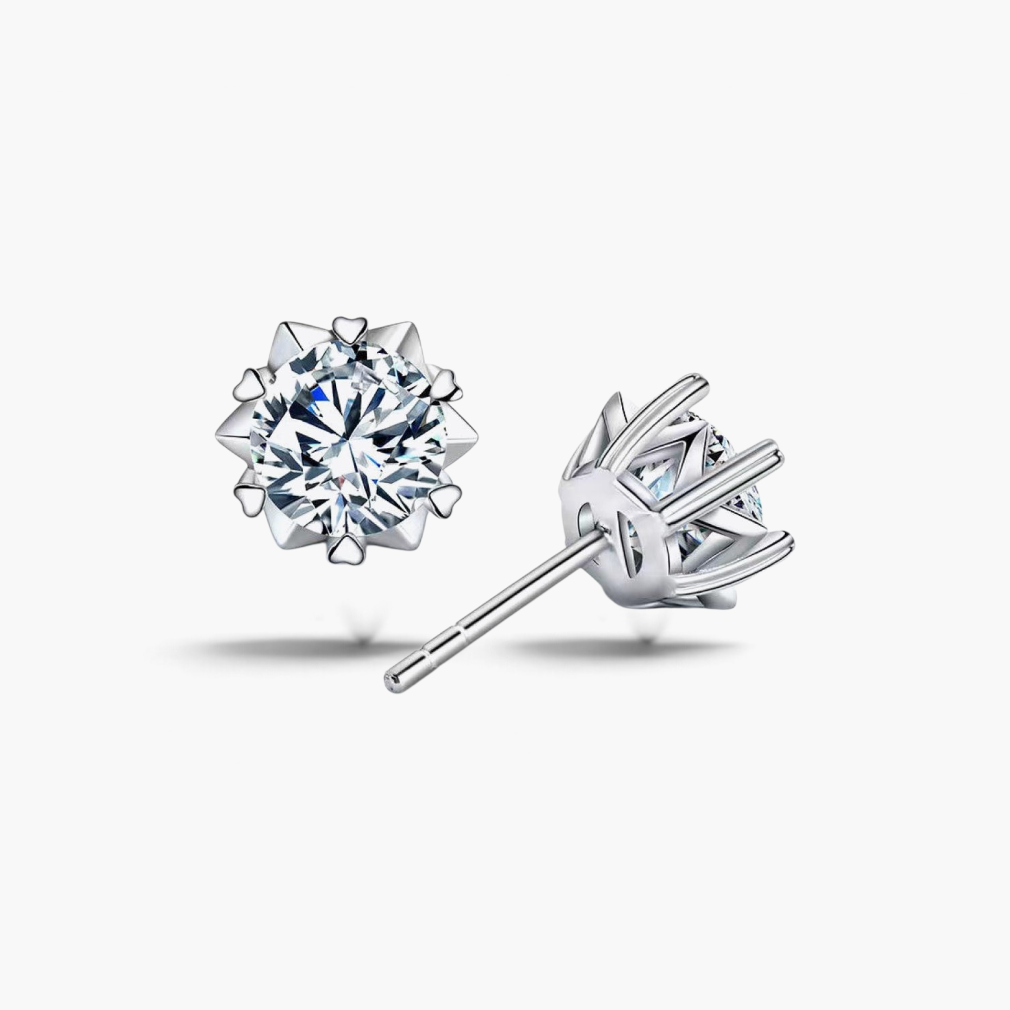 Beach Rose Co. silver starburst moissanite stud earrings with heart-shaped prongs and 4-carat total weight.