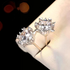 Beach Rose Co. silver starburst moissanite stud earrings with heart-shaped prongs and 4 carat total weight.