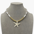 Beach Rose Co. 18K gold-plated necklace featuring elongated faux pearls, gold beads, and an iridescent starfish pendant.