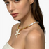 Beach Rose Co. 18K gold-plated necklace with faux pearl beads, gold spheres, and an iridescent starfish pendant.