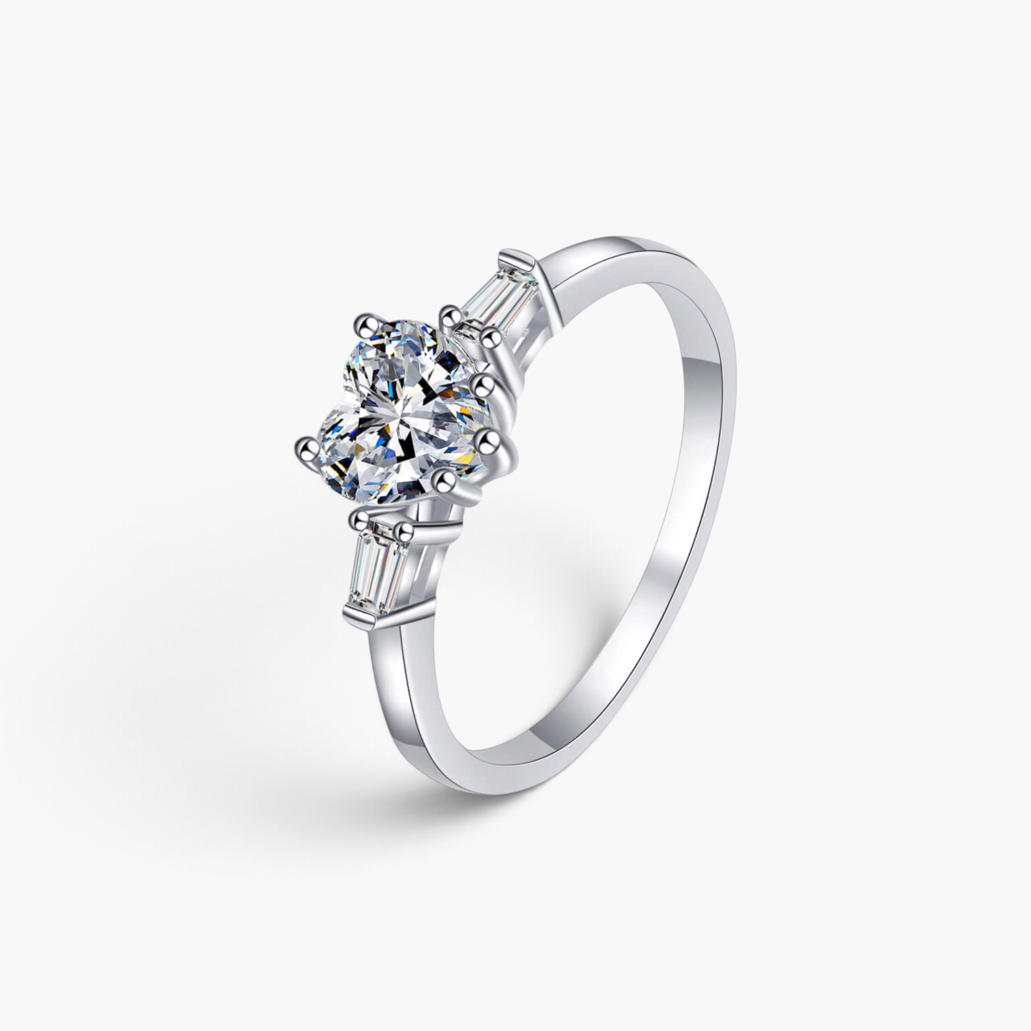 Beach Rose Co. sterling silver ring featuring a heart-shaped moissanite center stone and baguette side stones.