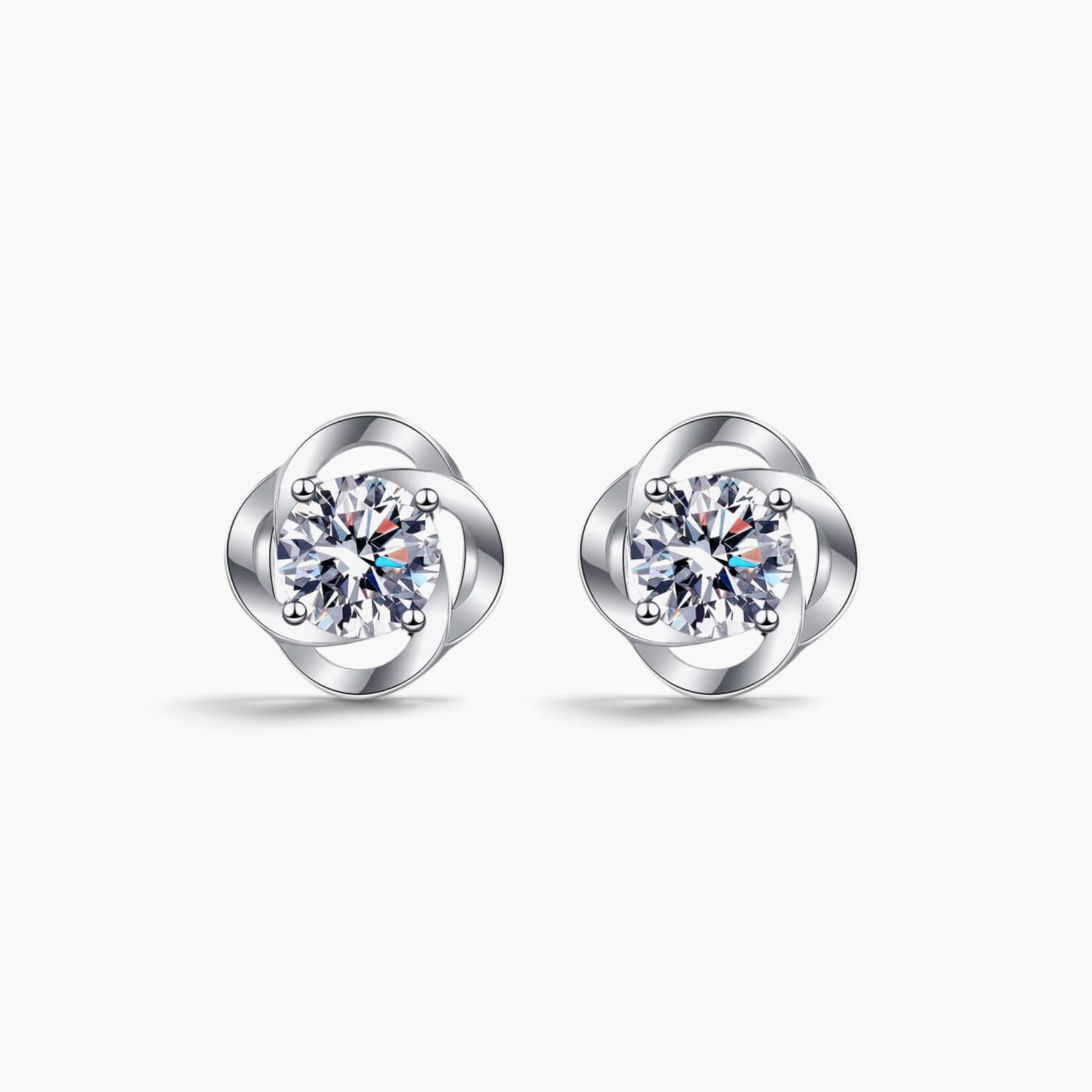Beach Rose Co. sterling silver flower stud earrings featuring round moissanite stones in a polished petal setting.