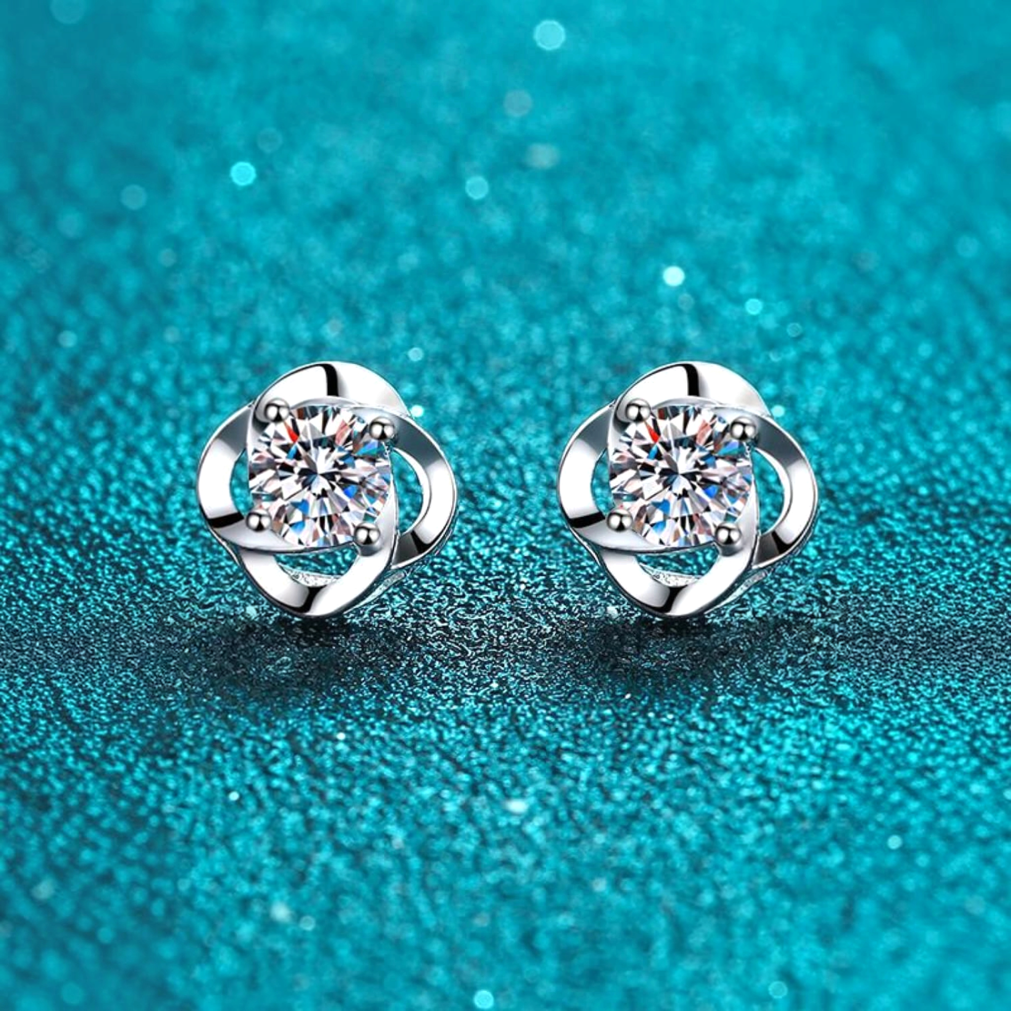 Beach Rose Co. sterling silver flower stud earrings featuring round moissanite stones with polished petal settings.