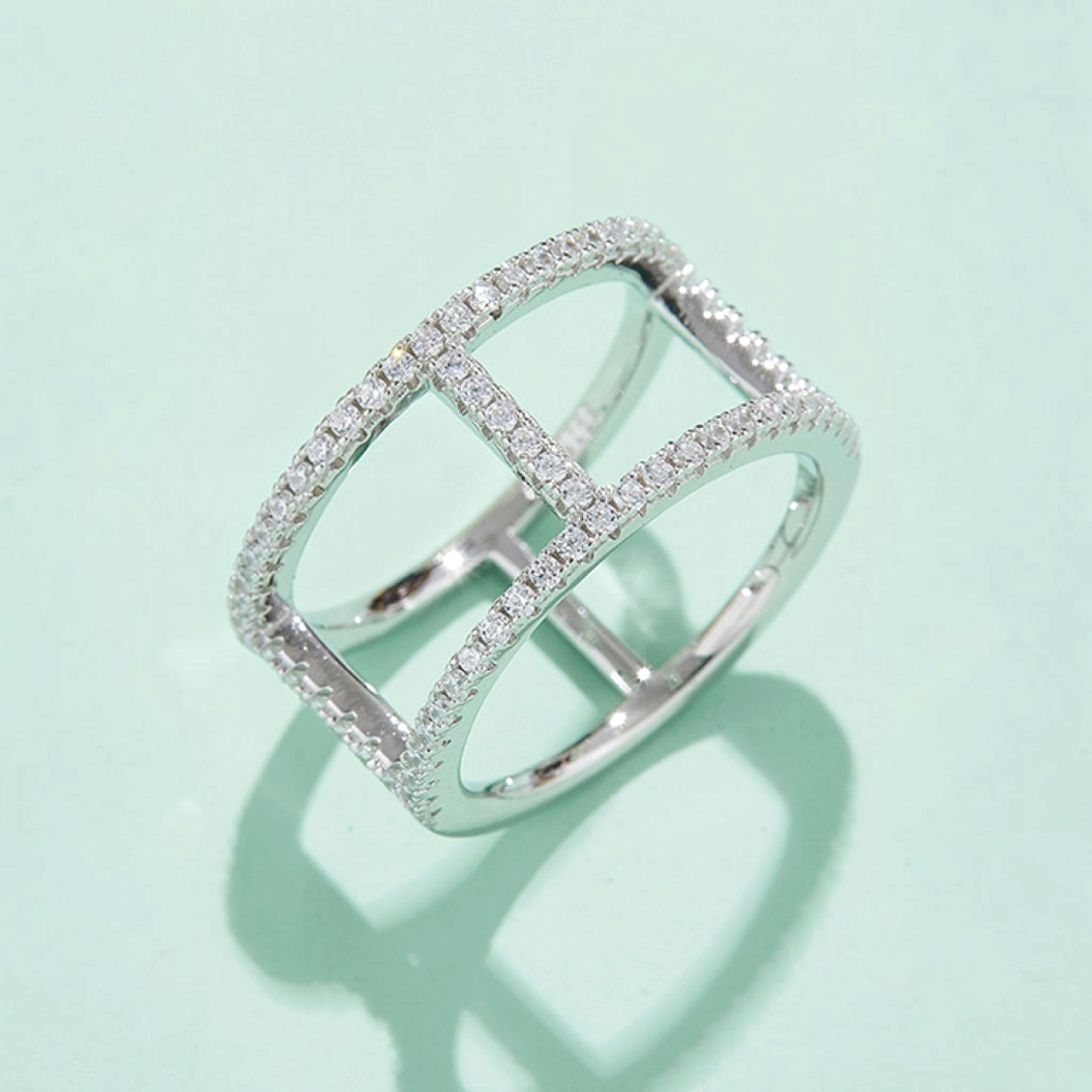 Beach Rose Co. sterling silver openwork ring featuring geometric bars and sparkling moissanite stones.