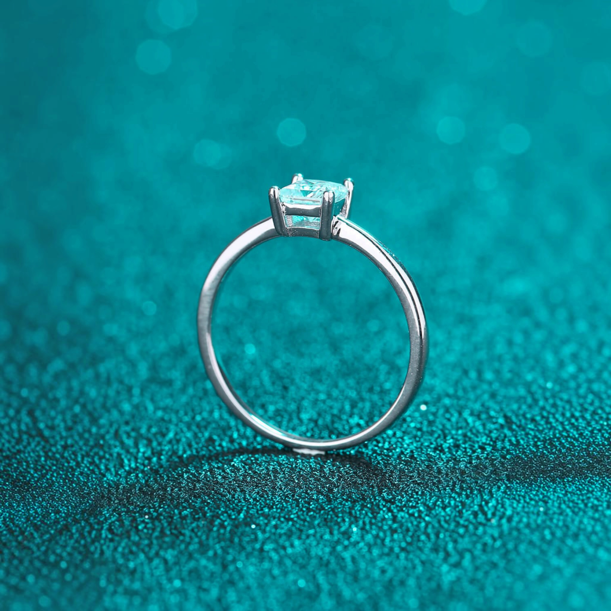 Beach Rose Co. sterling silver solitaire ring featuring a square moissanite stone in a four-prong setting.