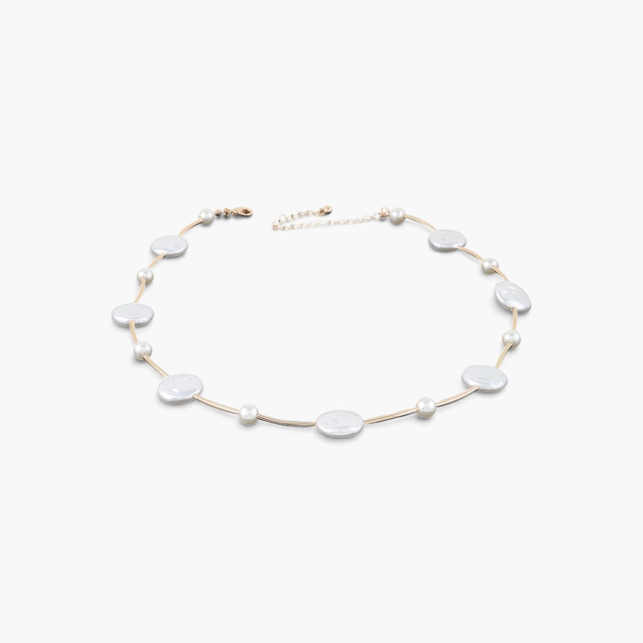Beach Rose Co. gold cream necklace featuring polished stone beads and delicate charms on a thin metallic chain