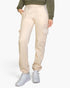 Beach Rose Co. stone-colored drawstring sweatpants with side cargo pockets worn by a model with white sneakers