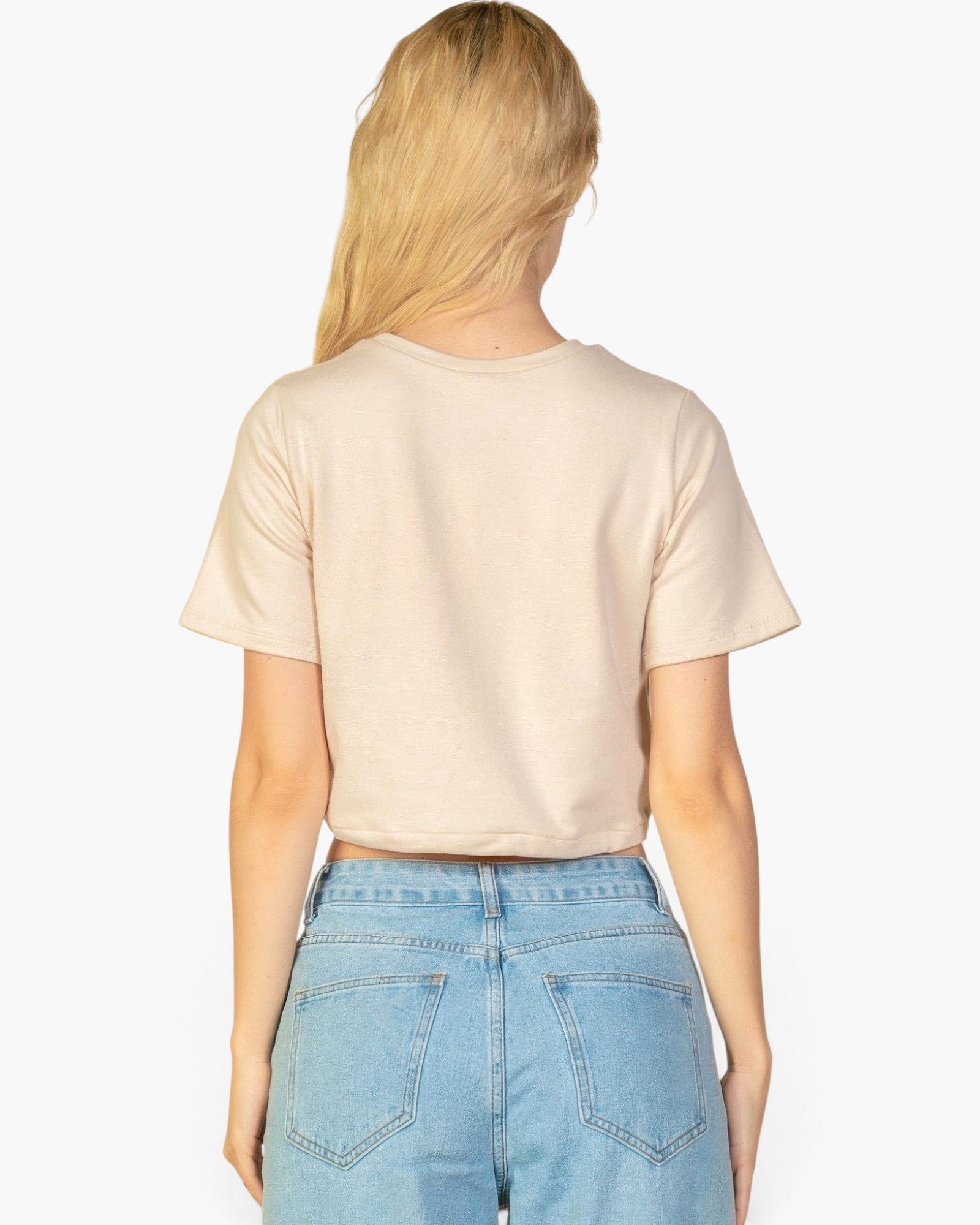 Beach Rose Co. stone coloured French Terry crop top with a toggle drawstring hem worn by a blonde woman from behind