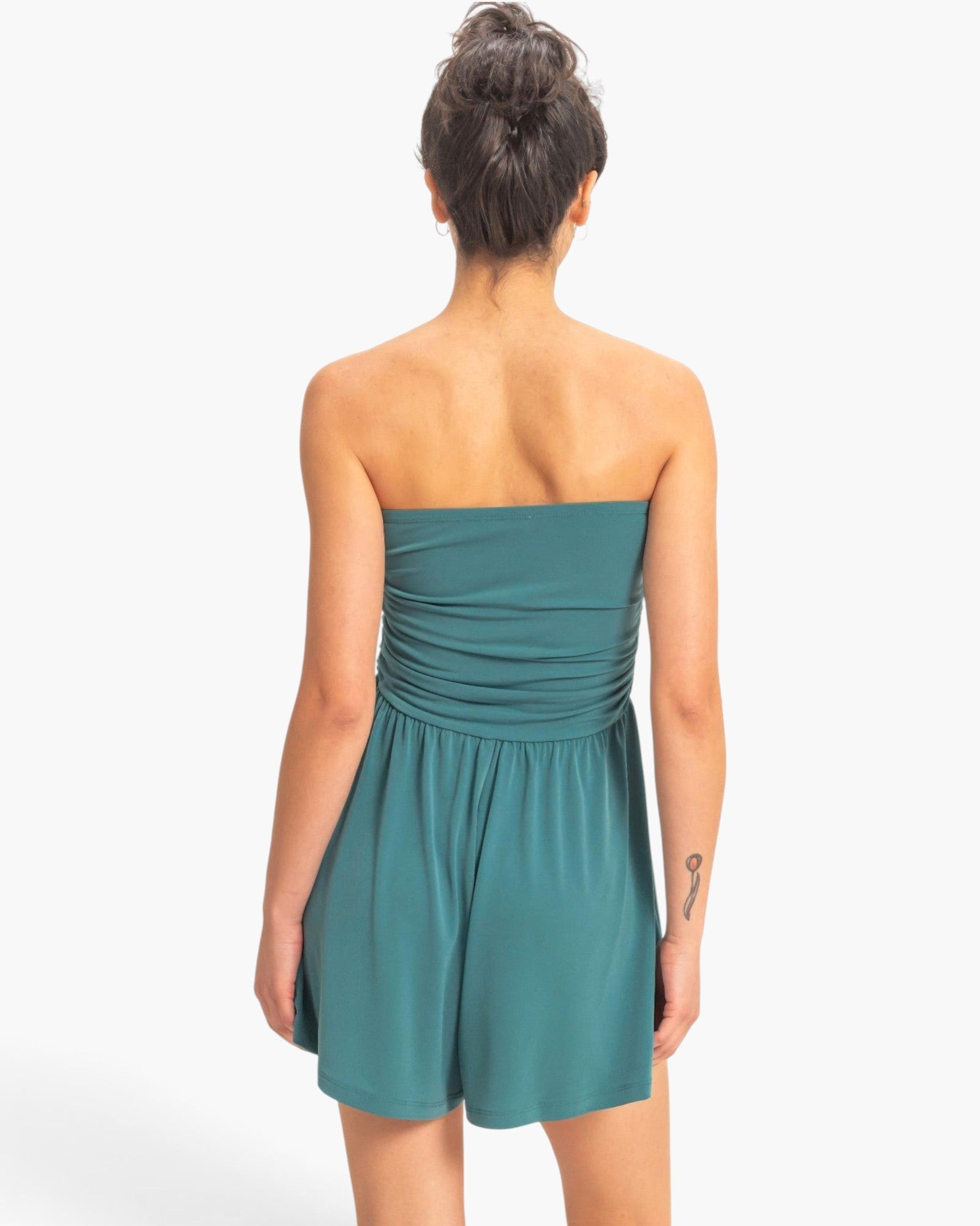 Beach Rose Co. strapless teal romper with shirred waist and relaxed shorts viewed from the back on a model